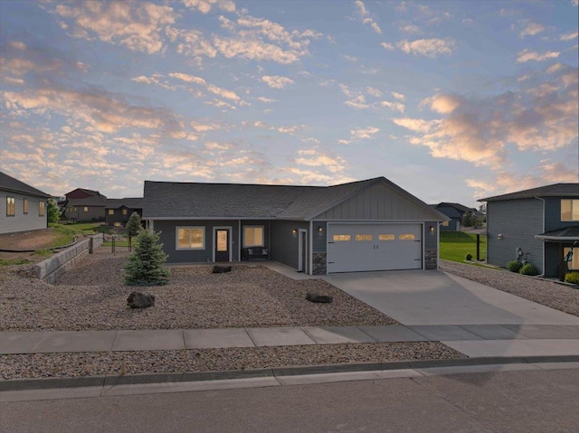 3781 W Beartooth Loop, Spearfish, SD 57783 - contemporary home featuring driveway, a garage, board and batten siding, and stone siding