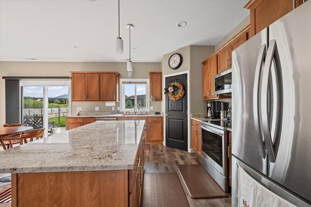 3781 W Beartooth Loop, Spearfish, SD 57783 - kitchen with appliances with stainless steel finishes, dark wood finished floors, brown cabinetry, and recessed lighting