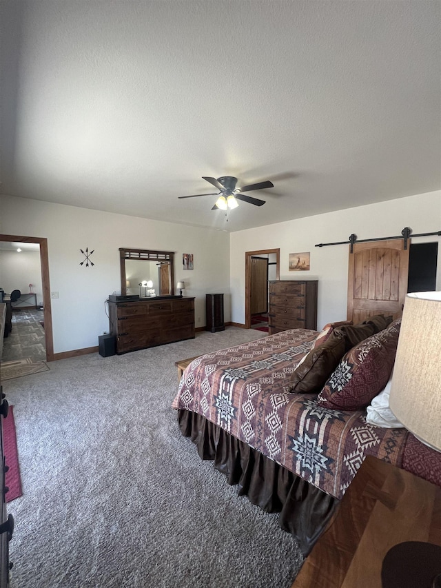 215 Meadowlark Dr, Hot Springs, SD 57747 - carpeted bedroom with a barn door, ceiling fan, and a textured ceiling