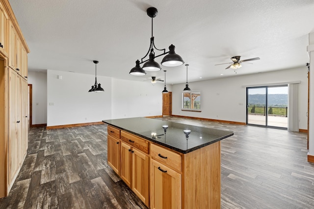 215 Meadowlark Dr, Hot Springs, SD 57747 - kitchen featuring ceiling fan, dark countertops, dark wood-style flooring, and open floor plan