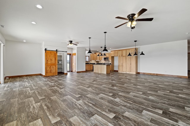 215 Meadowlark Dr, Hot Springs, SD 57747 - unfurnished living room featuring ceiling fan, dark wood-style flooring, a barn door, and recessed lighting