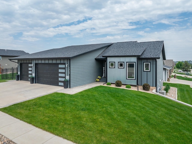 6315 Dunsmore Rd, Rapid City, SD 57702 - view of front of property with a garage, board and batten siding, roof with shingles, and concrete driveway