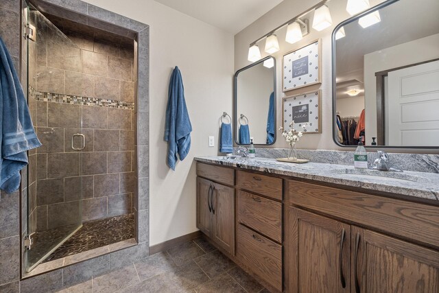 6315 Dunsmore Rd, Rapid City, SD 57702 - bathroom with double vanity, a shower stall, and stone finish flooring