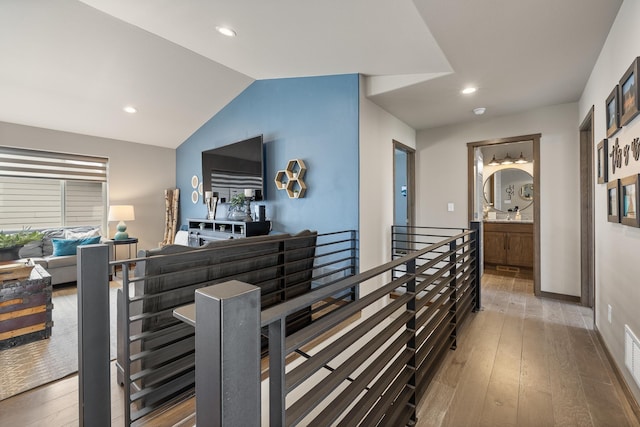 6315 Dunsmore Rd, Rapid City, SD 57702 - corridor with an upstairs landing, wood-type flooring, recessed lighting, and lofted ceiling
