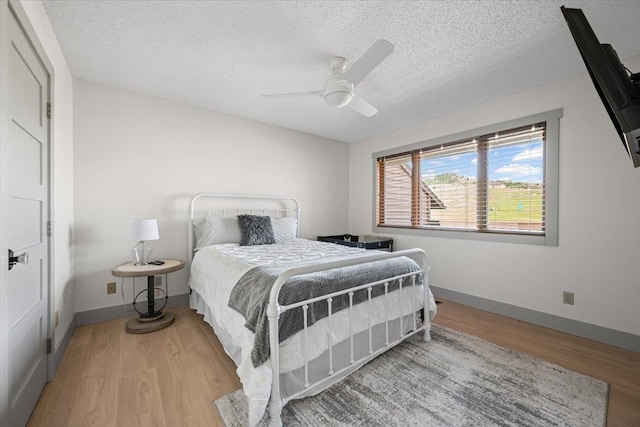 340 Fairway Dr, Spearfish, SD 57783 - bedroom with wood finished floors, a textured ceiling, and ceiling fan