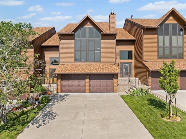 340 Fairway Dr, Spearfish, SD 57783 - view of front of home with concrete driveway, an attached garage, a chimney, and roof with shingles