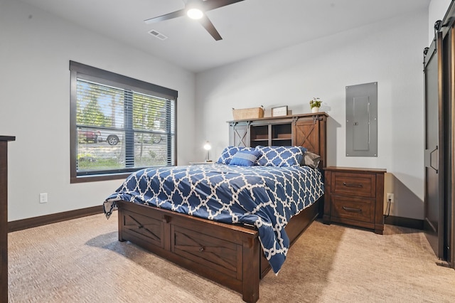21332 Trailside Rd, Lead, SD 57754 - carpeted bedroom featuring a barn door, electric panel, and ceiling fan