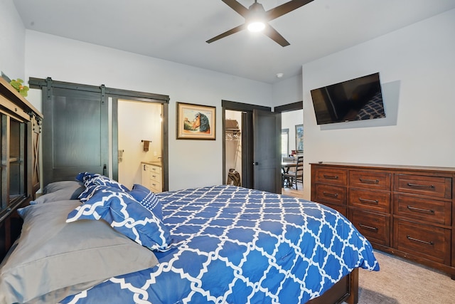 21332 Trailside Rd, Lead, SD 57754 - bedroom featuring a barn door, light carpet, ensuite bathroom, and a ceiling fan