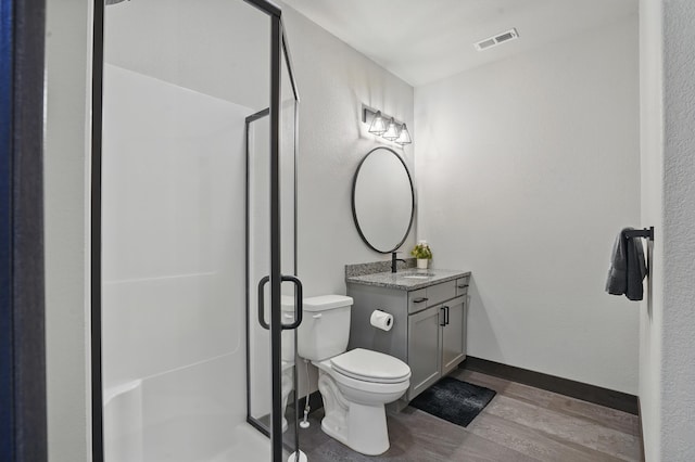 21332 Trailside Rd, Lead, SD 57754 - bathroom featuring wood finished floors, vanity, and a stall shower