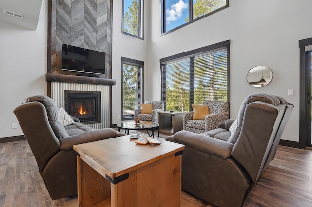 21332 Trailside Rd, Lead, SD 57754 - living room with plenty of natural light, a towering ceiling, wood finished floors, and a large fireplace