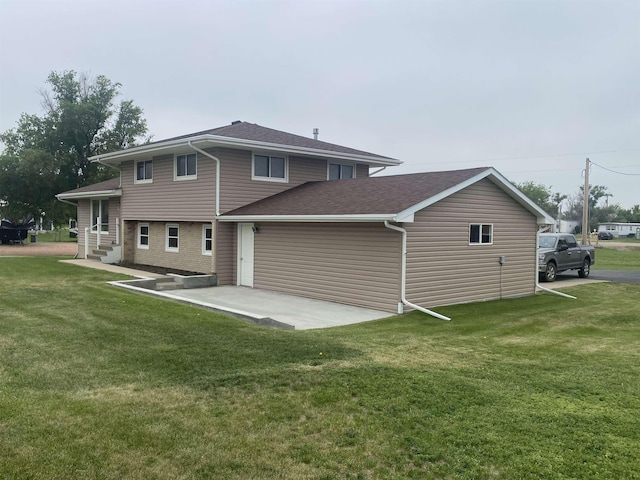 603 E 1st St, Buffalo, SD 57720 - rear view of property featuring a yard, a patio area, and a shingled roof