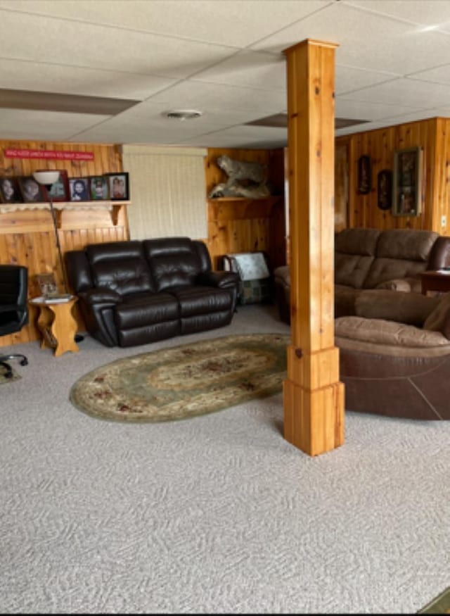 603 E 1st St, Buffalo, SD 57720 - living area with carpet flooring, wood walls, and a paneled ceiling