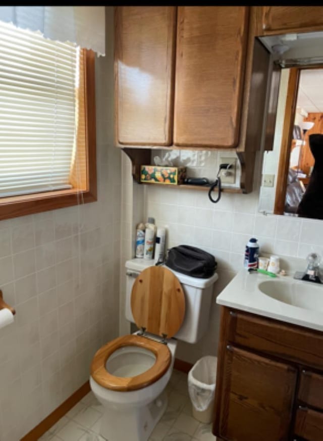 603 E 1st St, Buffalo, SD 57720 - bathroom with tile walls, vanity, and decorative backsplash