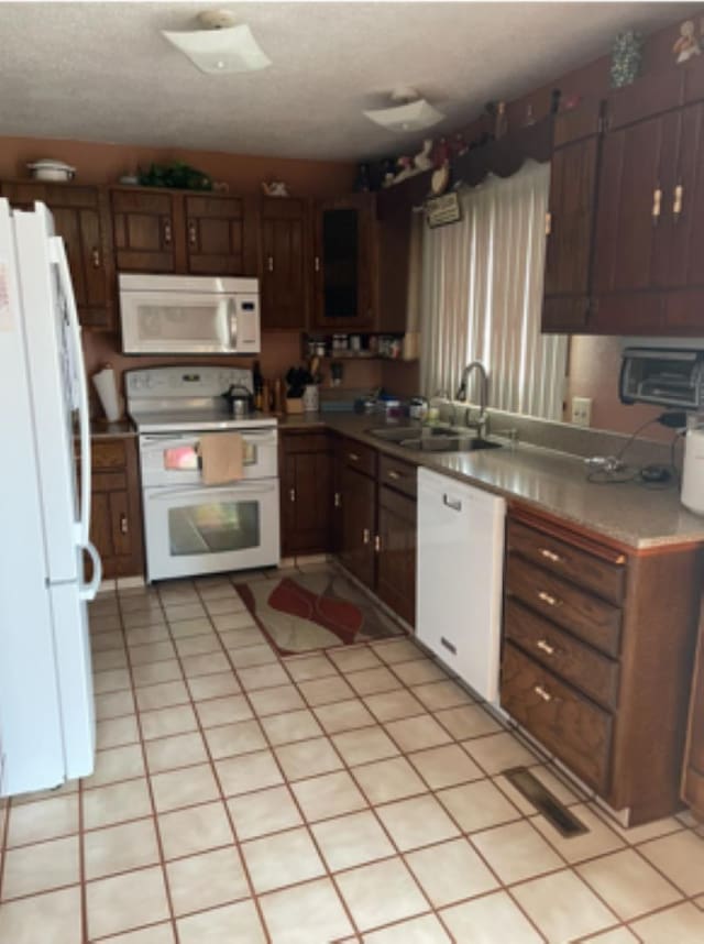 603 E 1st St, Buffalo, SD 57720 - kitchen featuring white appliances, a textured ceiling, and light countertops