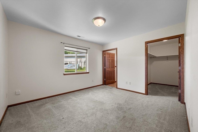 1233 Silverbrook Ln, Spearfish, SD 57783 - unfurnished bedroom featuring carpet flooring, a walk in closet, and a closet