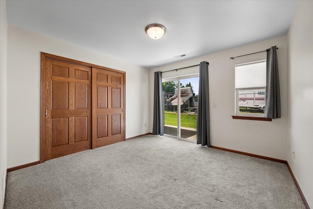 1233 Silverbrook Ln, Spearfish, SD 57783 - unfurnished bedroom with access to outside, carpet floors, and a closet