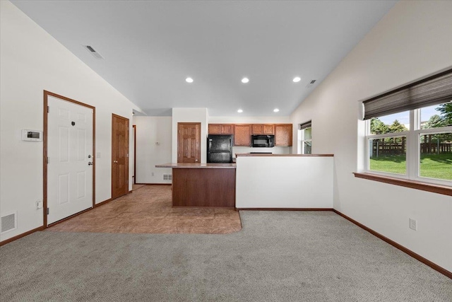 1233 Silverbrook Ln, Spearfish, SD 57783 - kitchen with black appliances, vaulted ceiling, light colored carpet, a peninsula, and recessed lighting