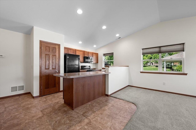 1233 Silverbrook Ln, Spearfish, SD 57783 - kitchen featuring black appliances, vaulted ceiling, recessed lighting, brown cabinetry, and a peninsula
