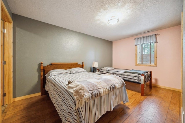2040 Aster Rd, Spearfish, SD 57783 - bedroom featuring hardwood / wood-style flooring and a textured ceiling