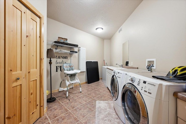 2040 Aster Rd, Spearfish, SD 57783 - laundry area with cabinet space, separate washer and dryer, a textured ceiling, and light tile patterned floors
