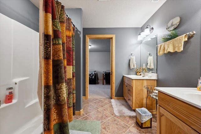 2040 Aster Rd, Spearfish, SD 57783 - bathroom with two vanities, tile patterned floors, a shower with shower curtain, and a textured ceiling