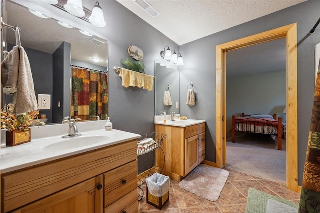 2040 Aster Rd, Spearfish, SD 57783 - ensuite bathroom featuring tile patterned flooring, two vanities, and a textured ceiling