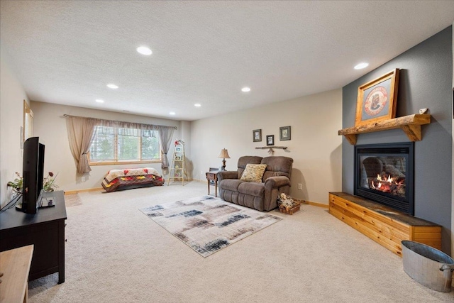 2040 Aster Rd, Spearfish, SD 57783 - living room featuring a glass covered fireplace, carpet, recessed lighting, and a textured ceiling
