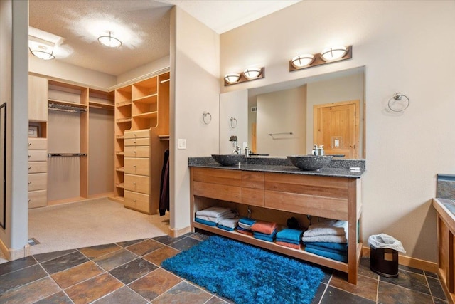 2040 Aster Rd, Spearfish, SD 57783 - full bath with vanity, a spacious closet, and stone finish floors