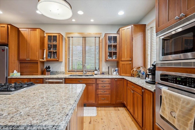 2040 Aster Rd, Spearfish, SD 57783 - kitchen featuring stainless steel appliances, light wood finished floors, brown cabinets, and recessed lighting