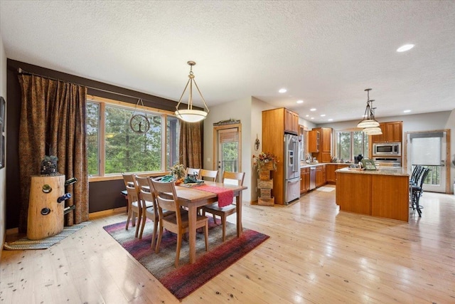 2040 Aster Rd, Spearfish, SD 57783 - dining area with light wood-type flooring, a textured ceiling, and recessed lighting