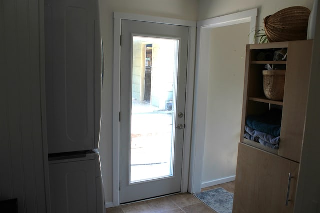 126 E Saint Andrew St, Rapid City, SD 57701 - doorway featuring stacked washer and clothes dryer and light tile patterned floors