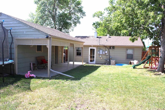 126 E Saint Andrew St, Rapid City, SD 57701 - back of property featuring a patio, a playground, a lawn, and a trampoline