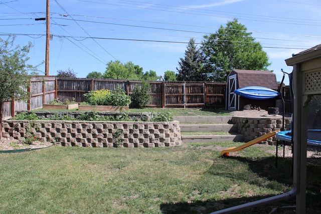 126 E Saint Andrew St, Rapid City, SD 57701 - fenced backyard featuring a trampoline, a garden, and a shed