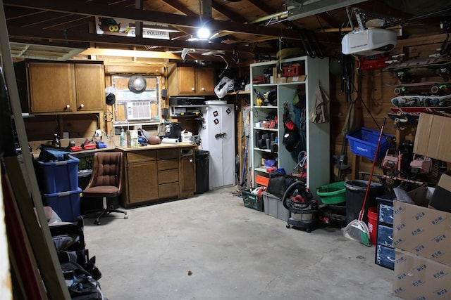 126 E Saint Andrew St, Rapid City, SD 57701 - garage featuring a garage door opener and a workshop area