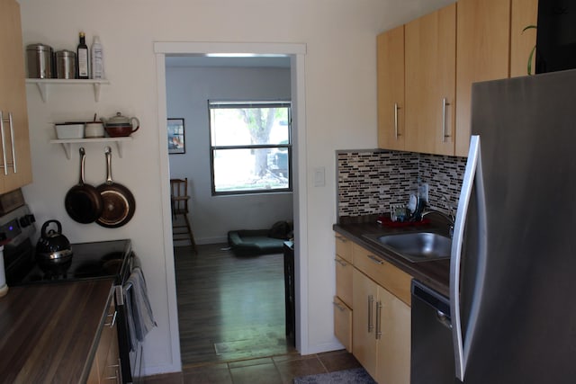 126 E Saint Andrew St, Rapid City, SD 57701 - kitchen featuring appliances with stainless steel finishes, dark countertops, backsplash, dark tile patterned flooring, and light brown cabinets