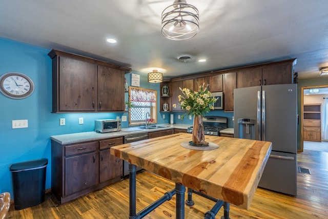 627 W Mt Rushmore Rd, Custer, SD 57730 - kitchen with appliances with stainless steel finishes, dark brown cabinets, wood finished floors, and recessed lighting