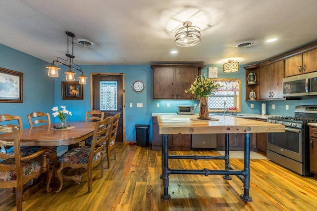 627 W Mt Rushmore Rd, Custer, SD 57730 - kitchen with appliances with stainless steel finishes, butcher block counters, wood finished floors, and recessed lighting