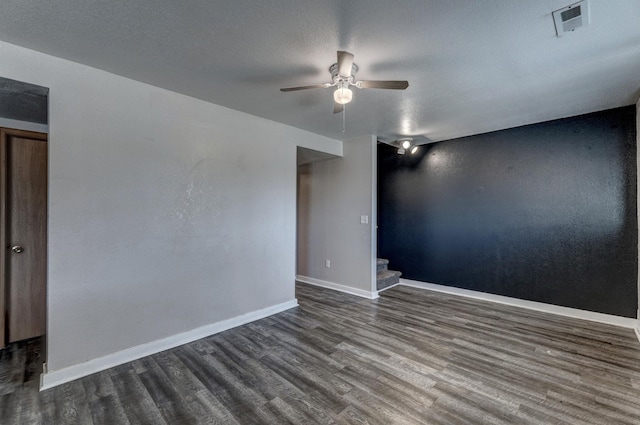 212 E Custer St, Rapid City, SD 57701 - spare room with dark wood-style floors, a ceiling fan, and stairway