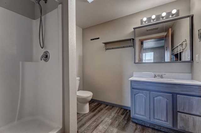 212 E Custer St, Rapid City, SD 57701 - full bath featuring wood finished floors, a stall shower, and vanity