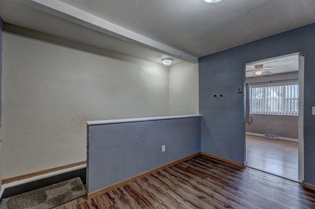 212 E Custer St, Rapid City, SD 57701 - empty room featuring wood finished floors, a textured ceiling, and a ceiling fan