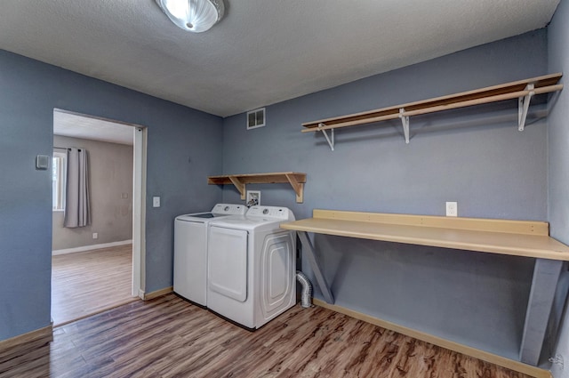 212 E Custer St, Rapid City, SD 57701 - washroom featuring washing machine and dryer, wood finished floors, and a textured ceiling