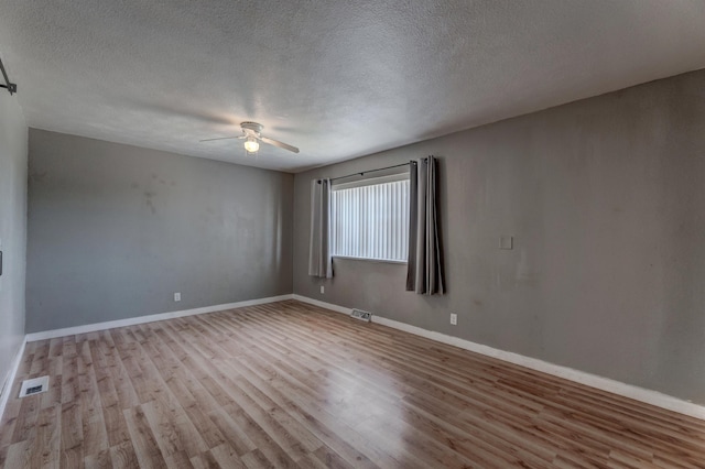 212 E Custer St, Rapid City, SD 57701 - unfurnished room featuring wood finished floors, a ceiling fan, and a textured ceiling