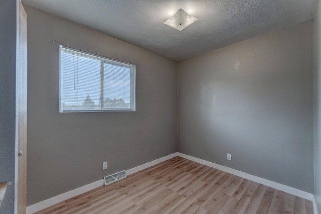 212 E Custer St, Rapid City, SD 57701 - unfurnished room featuring light wood-style floors and a textured ceiling