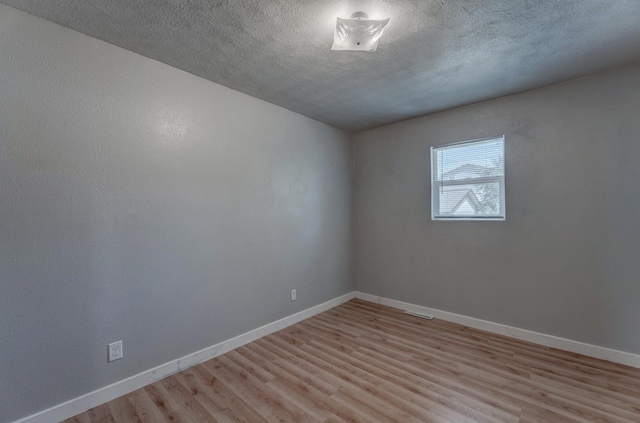 212 E Custer St, Rapid City, SD 57701 - empty room featuring light wood finished floors and a textured ceiling