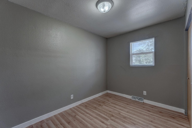 212 E Custer St, Rapid City, SD 57701 - unfurnished room featuring light wood-type flooring and a textured ceiling
