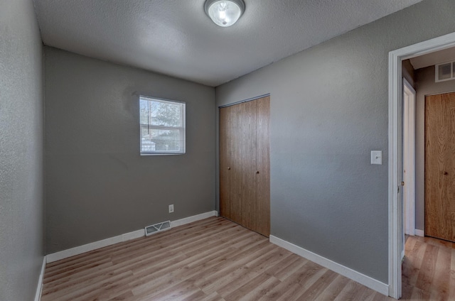 212 E Custer St, Rapid City, SD 57701 - unfurnished bedroom featuring light wood-style flooring and a closet