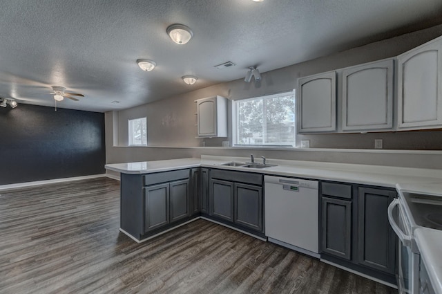 212 E Custer St, Rapid City, SD 57701 - kitchen with dishwasher, a peninsula, electric range oven, a textured ceiling, and dark wood finished floors