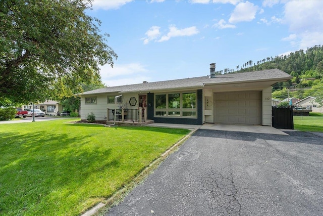 10 Crescent Dr, Deadwood, SD 57732 - view of front facade with an attached garage, a front yard, and asphalt driveway
