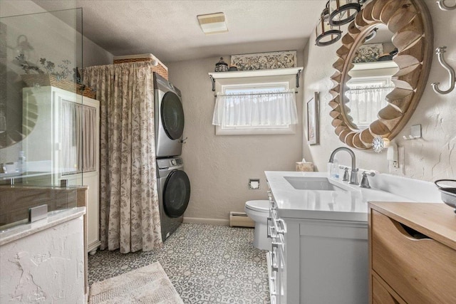 10 Crescent Dr, Deadwood, SD 57732 - bathroom with stacked washer and clothes dryer, vanity, curtained shower, baseboard heating, and a textured ceiling