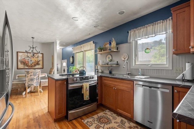 10 Crescent Dr, Deadwood, SD 57732 - kitchen with stainless steel appliances, brown cabinets, and light wood-style flooring